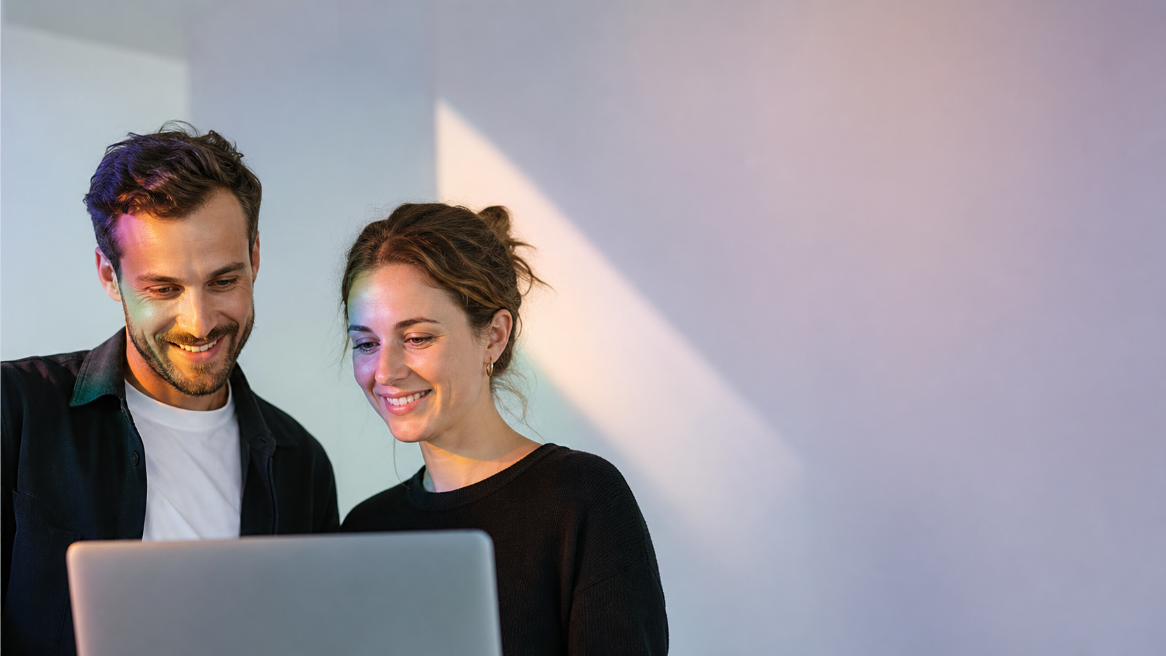 A close-up of two professional marketing consultants collaborating in a bright, modern agency workspace with clean copy space.